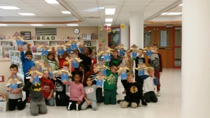 Scarecrows_1 First graders with the puppet scarecrows they made in library.